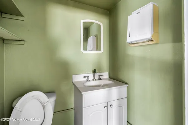 a picture of a bathroom with sink and mirror