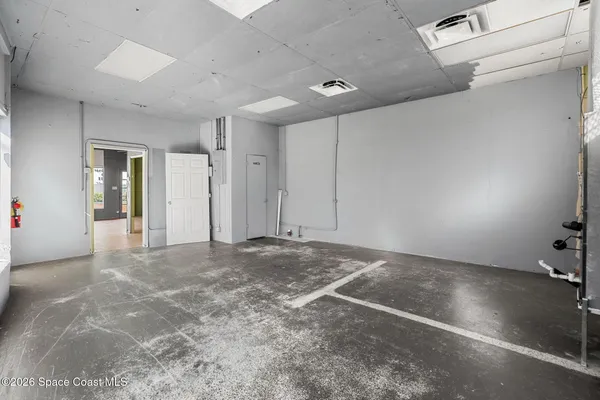a view of a hallway with wooden floor and a sink