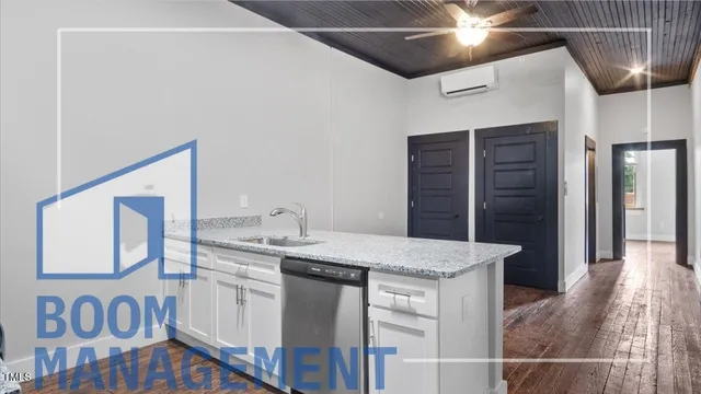 a kitchen with a sink a refrigerator and chandelier