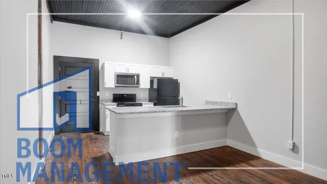 a view of kitchen with furniture and wooden floor