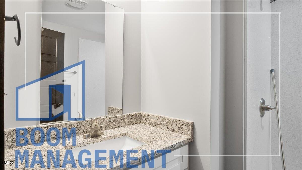 202 South Main Street, Unit 1BR 1 Bath, NC 27808 - Photo 18 of 31 a bathroom with a sink and a mirror