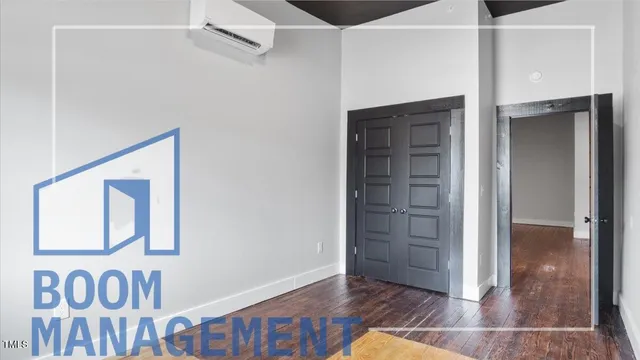 an empty room with wooden floor and closet