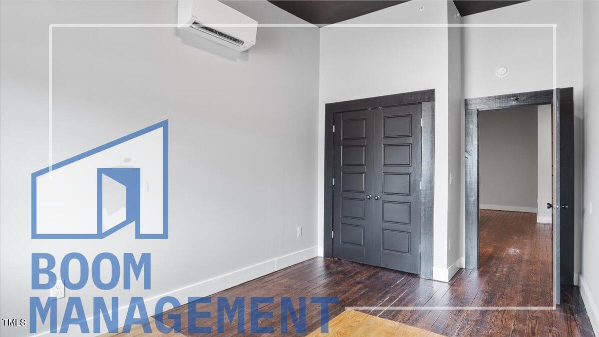 202 South Main Street, Unit 1BR 1 Bath, NC 27808 - Photo 26 of 31 an empty room with wooden floor and closet