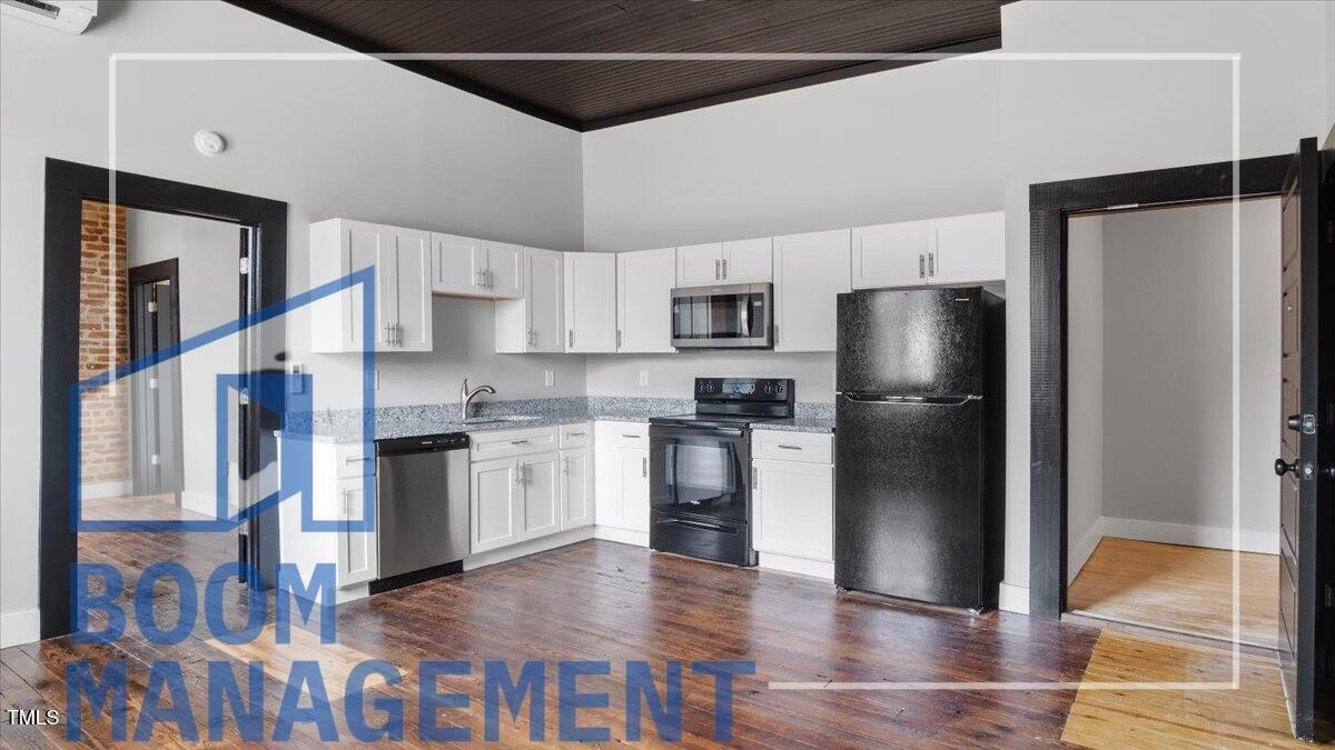 202 South Main Street, Unit 1BR 1 Bath, NC 27808 - Photo 4 of 31 a kitchen with a refrigerator and a stove top oven