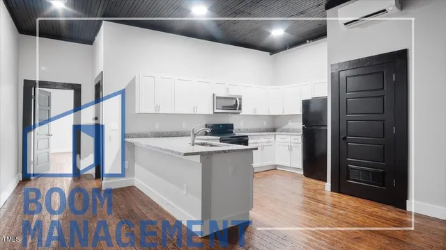 a kitchen with stainless steel appliances granite countertop a refrigerator and a stove top oven