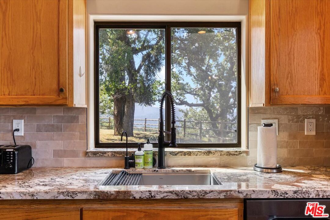 28081 Deertrail Drive Tehachapi, CA 93561 - Photo 13 of 31 a kitchen with granite countertop sink and cabinets