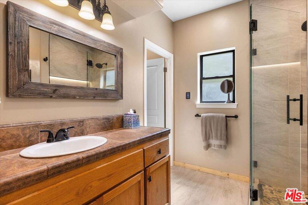 28081 Deertrail Drive Tehachapi, CA 93561 - Photo 15 of 31 a bathroom with a sink and a mirror