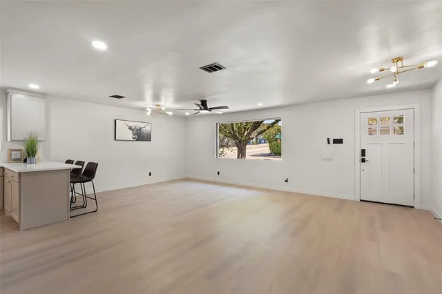 an empty room with windows and furniture