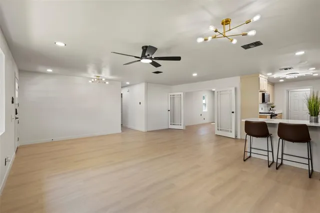 a view of an empty room with a ceiling fan