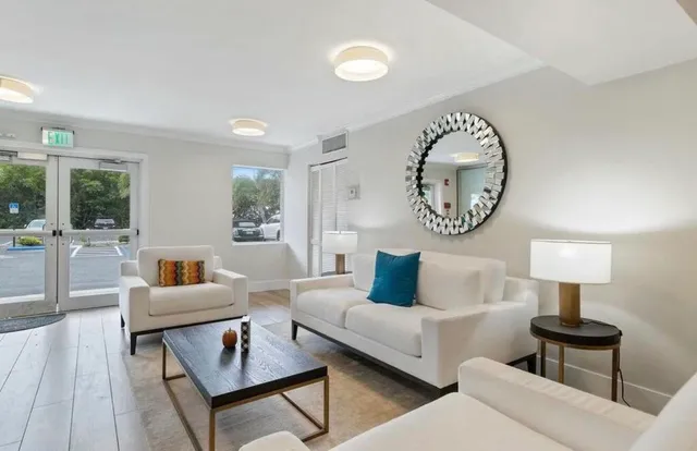 a living room with furniture and a lamp