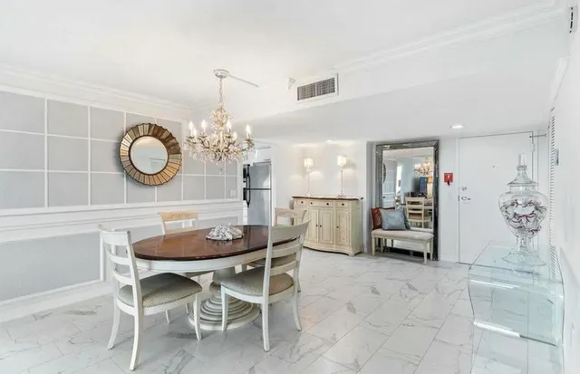 a dining room with furniture and chandelier