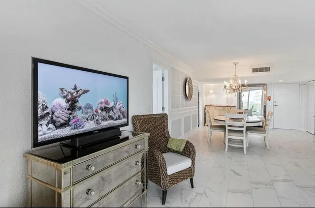 a living room with furniture and a painting on the wall