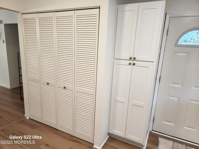 a view of a room with wooden floor