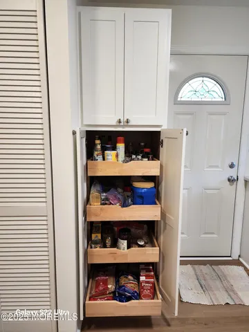 a view of a bedroom with rack and book shelf