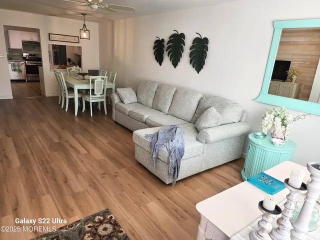 a living room with furniture and a wooden floor