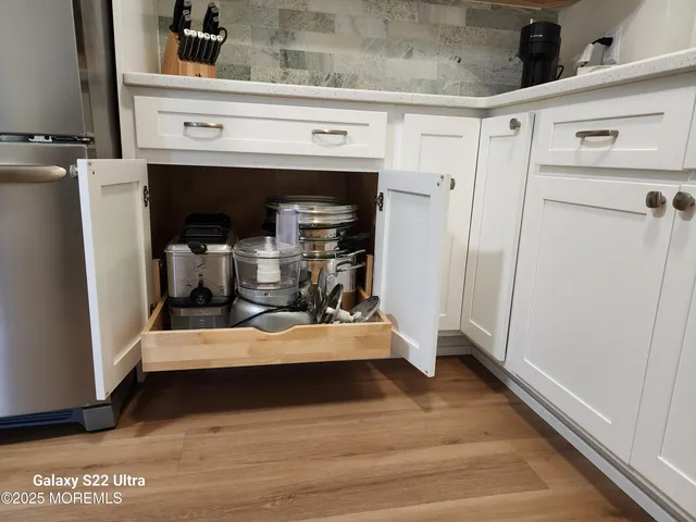 a view of room with wooden floor