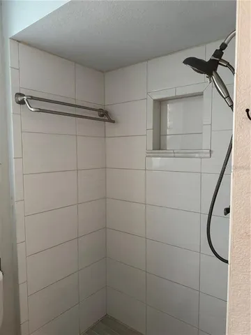 a bathroom with a shower and a mirror