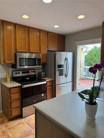 a kitchen with a refrigerator and a sink