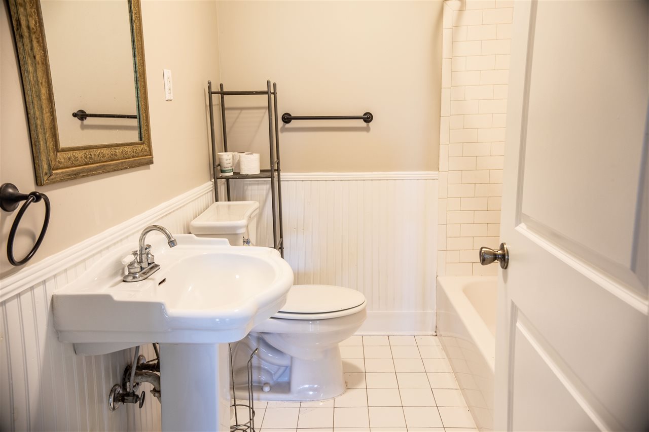 8916 Deadfall Road Millington, TN 38053 - Photo 8 of 13 Bead Board 3/4th up wall in Bath w/ Shower and Tub. Owner had all redone. White tile brightens all and don't forget the Linen Closet.