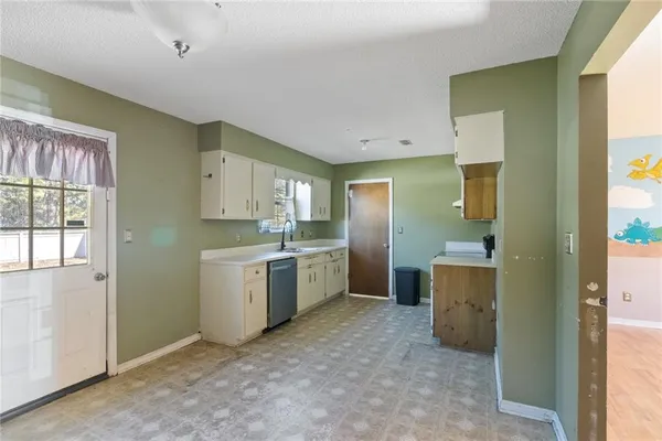 a kitchen with a sink a stove top oven and refrigerator