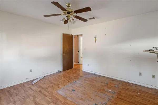 a view of a livingroom with a ceiling fan and window