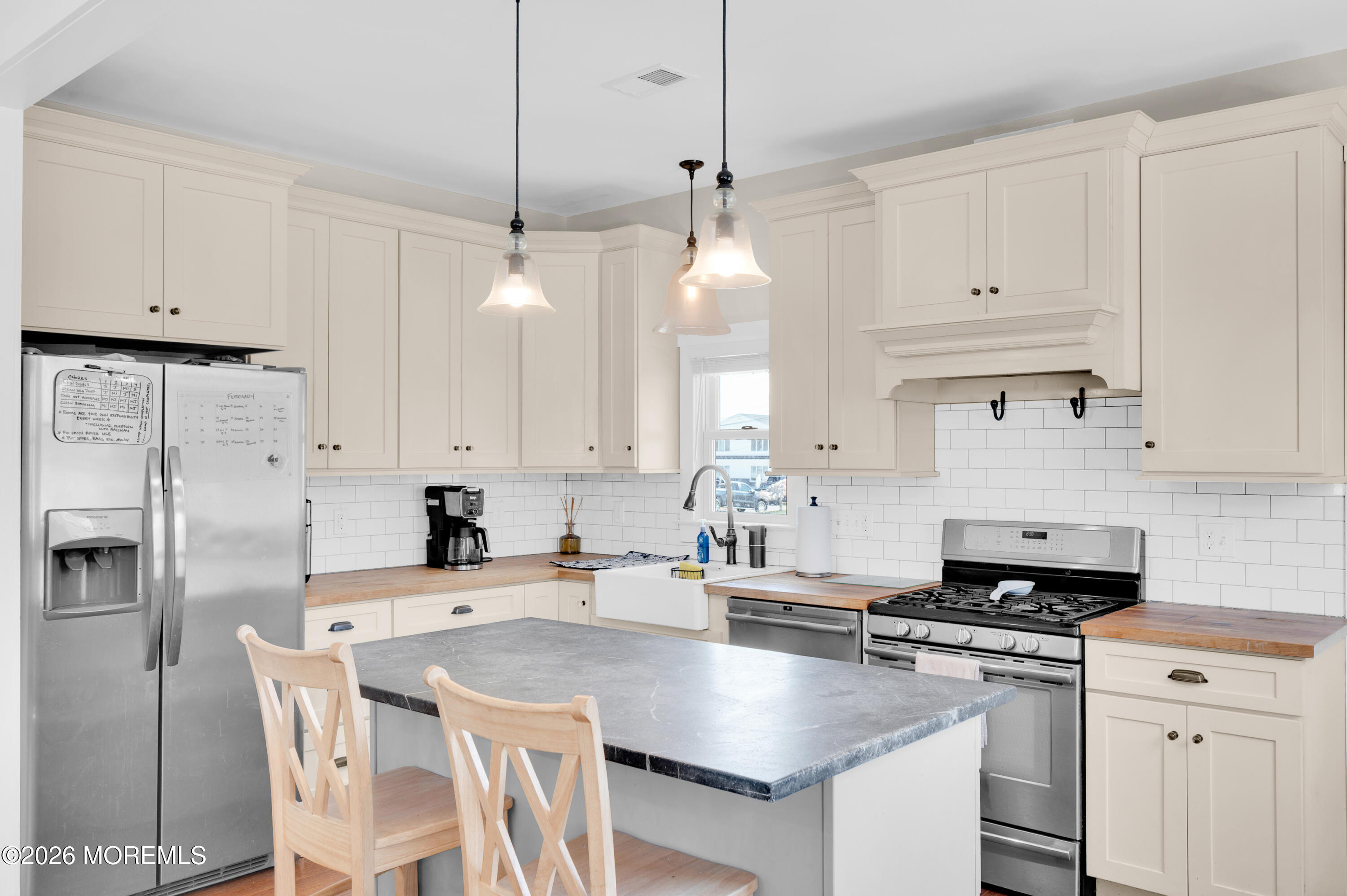 203 Riviera Drive Toms River, NJ 08753 - Photo 16 of 37 a kitchen with stainless steel appliances a stove a sink a refrigerator a white table and chairs