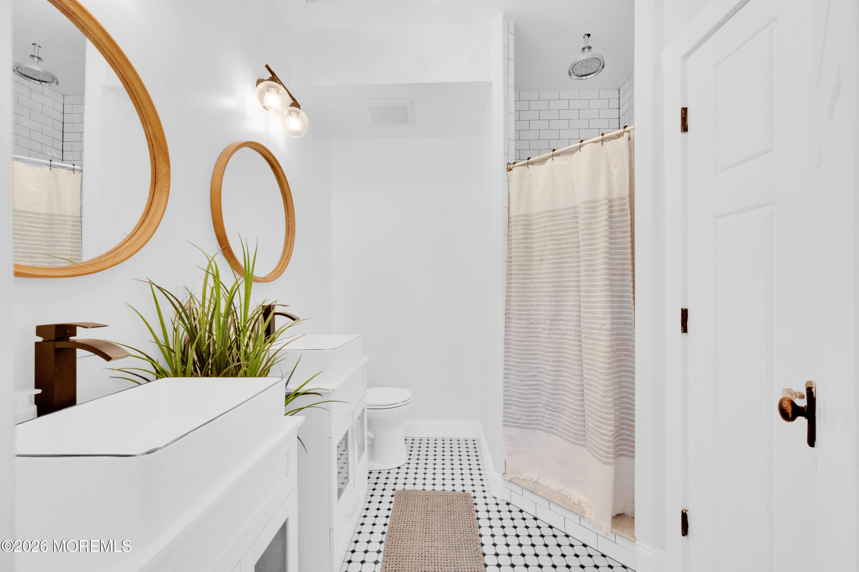 203 Riviera Drive Toms River, NJ 08753 - Photo 21 of 37 a bathroom with a sink a mirror and a shower