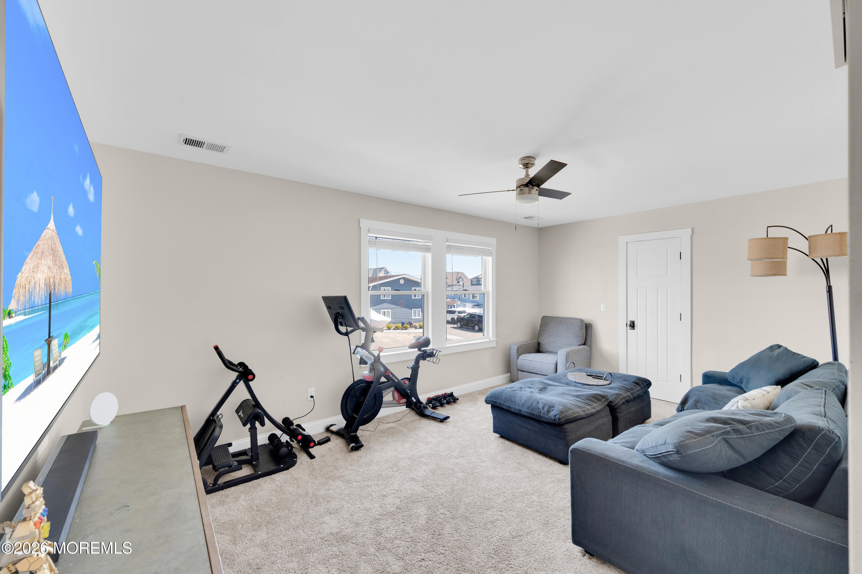 203 Riviera Drive Toms River, NJ 08753 - Photo 22 of 37 a living room with furniture a window and a flat screen tv