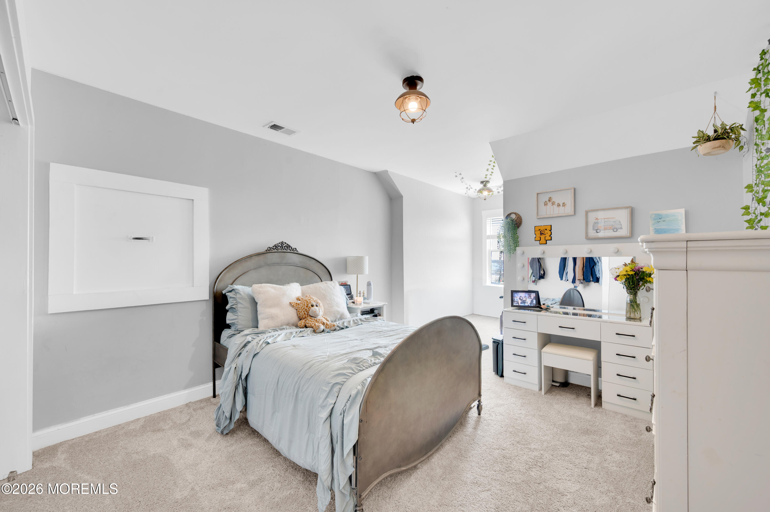 203 Riviera Drive Toms River, NJ 08753 - Photo 24 of 37 a bedroom with a bed and a chandelier
