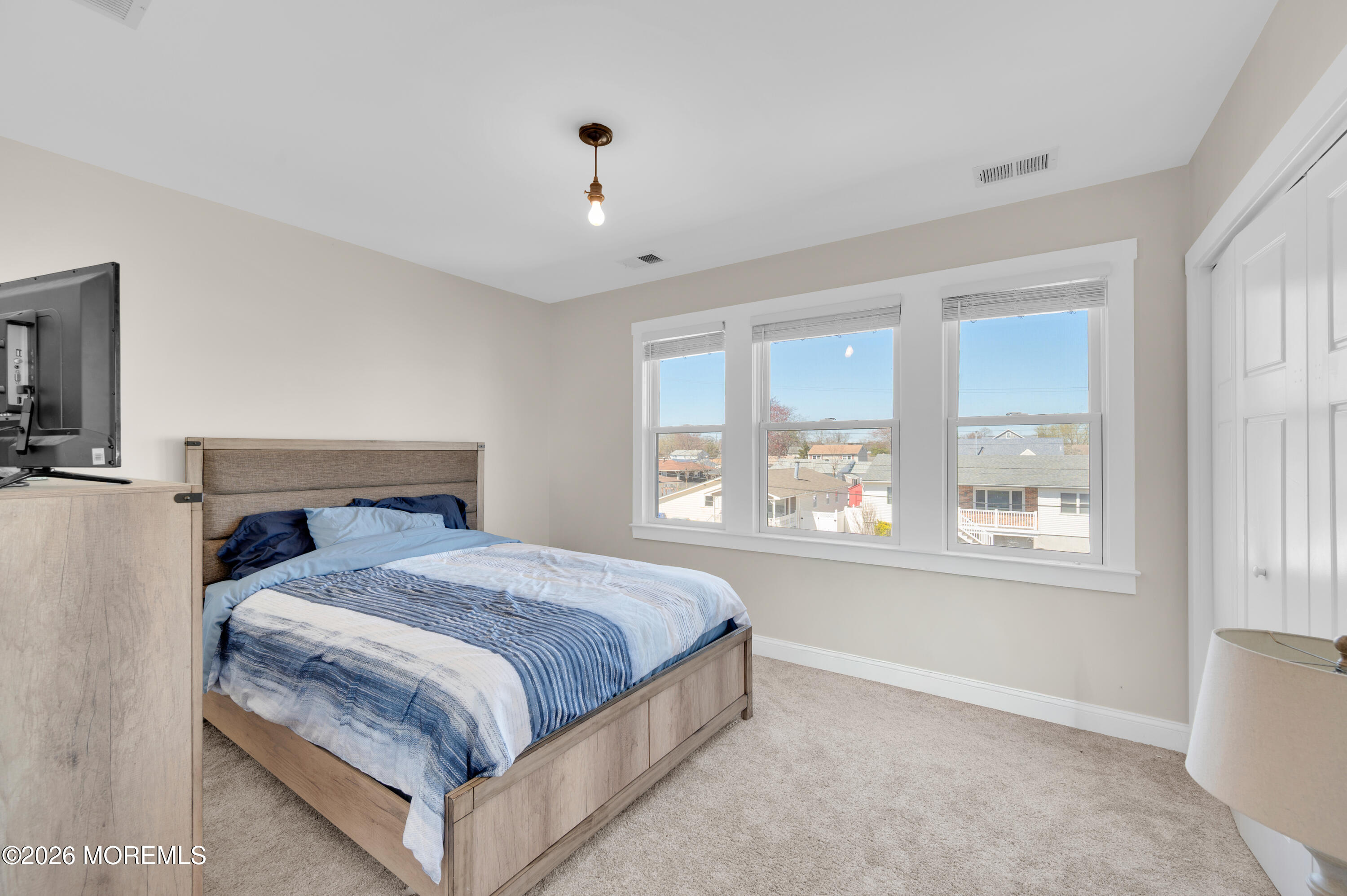 203 Riviera Drive Toms River, NJ 08753 - Photo 27 of 37 a bedroom with a large bed and a large window