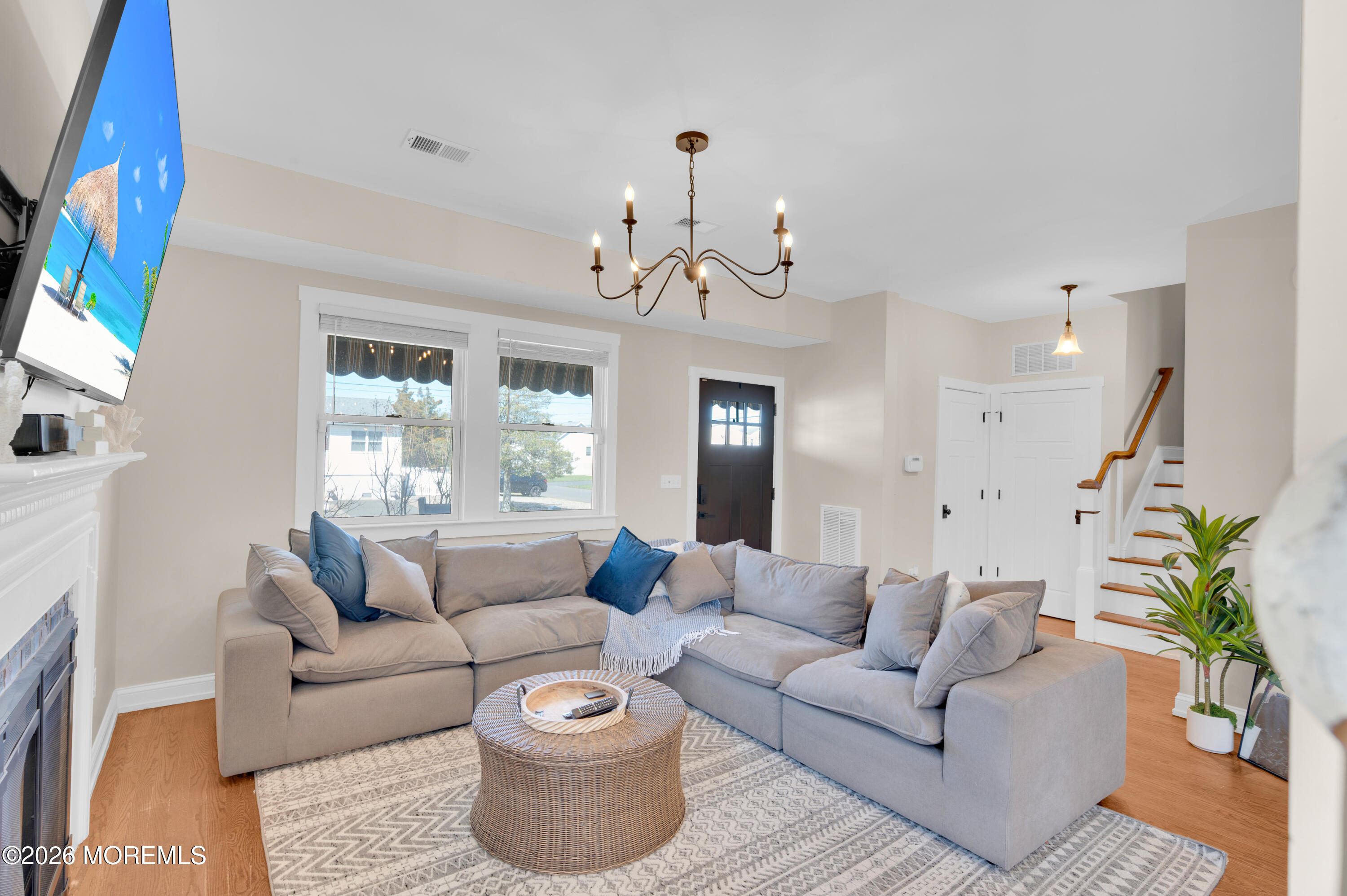 203 Riviera Drive Toms River, NJ 08753 - Photo 6 of 37 a living room with furniture and a chandelier