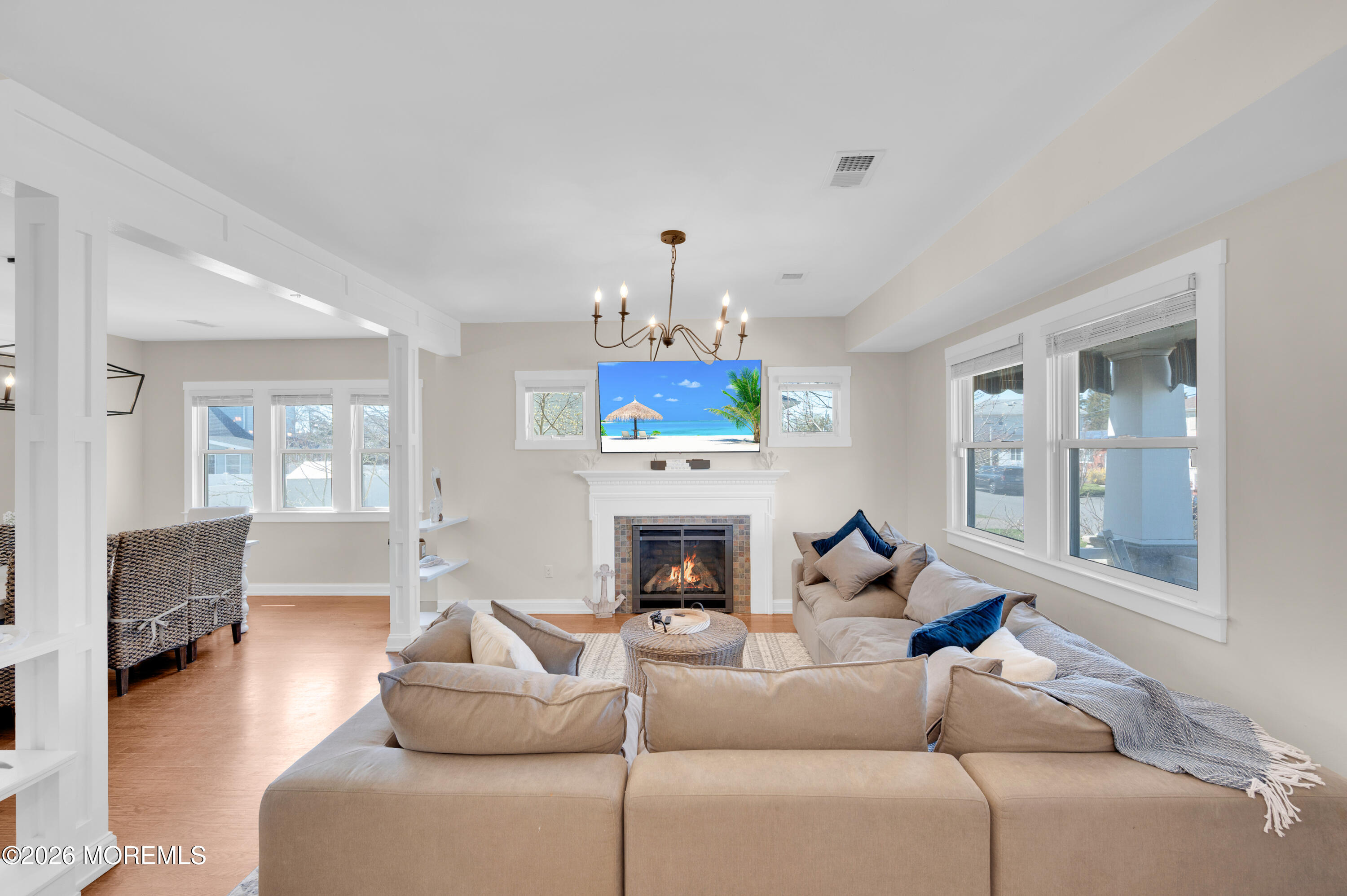 203 Riviera Drive Toms River, NJ 08753 - Photo 7 of 37 a living room with furniture a fireplace and a chandelier