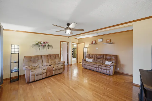 a living room with furniture and a wooden floor