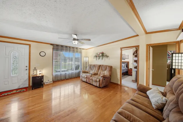 a living room with furniture and a wooden floor