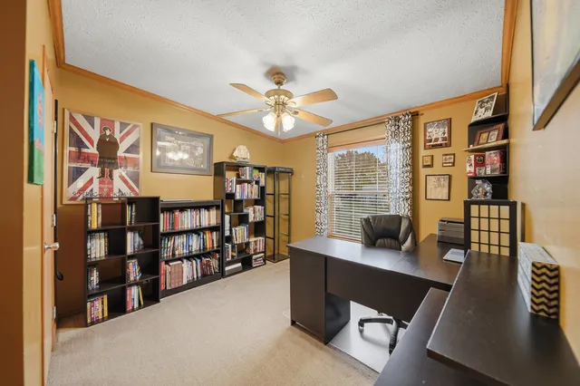 a work room with furniture and a bookshelf