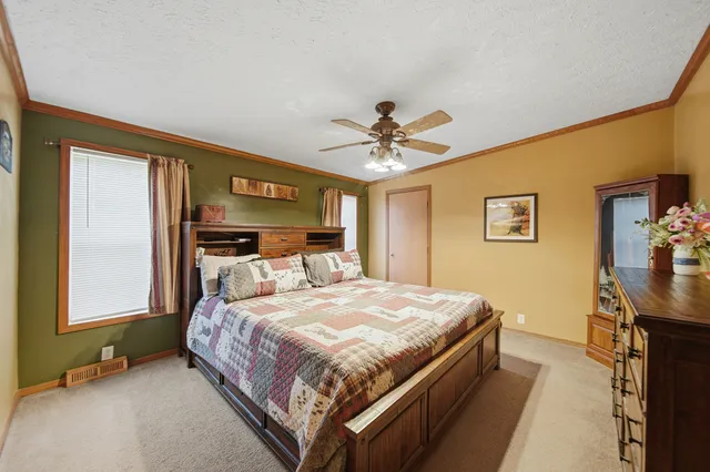 a bedroom with a bed and a chandelier