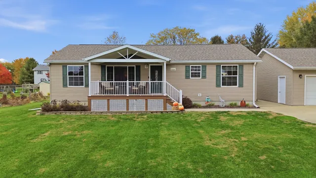 a front view of a house with a garden