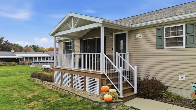 a view of house with a yard and deck