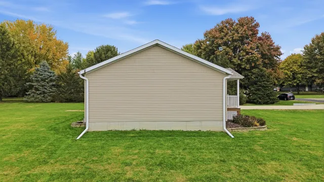 a view of a backyard with barn and large trees