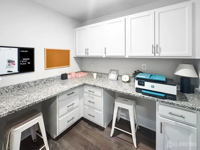 a kitchen with granite countertop white cabinets and white appliances