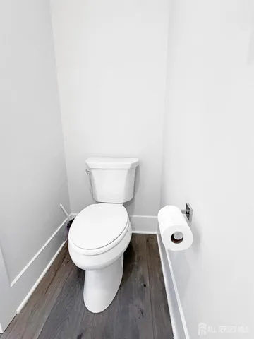 a white toilet sitting next to a white sink