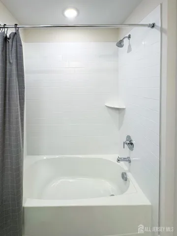a bathroom with a shower and a bath tub