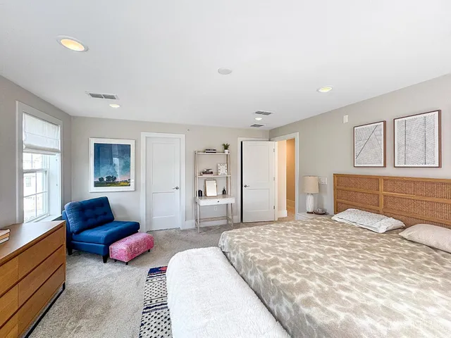 a bedroom with a large bed and a couch