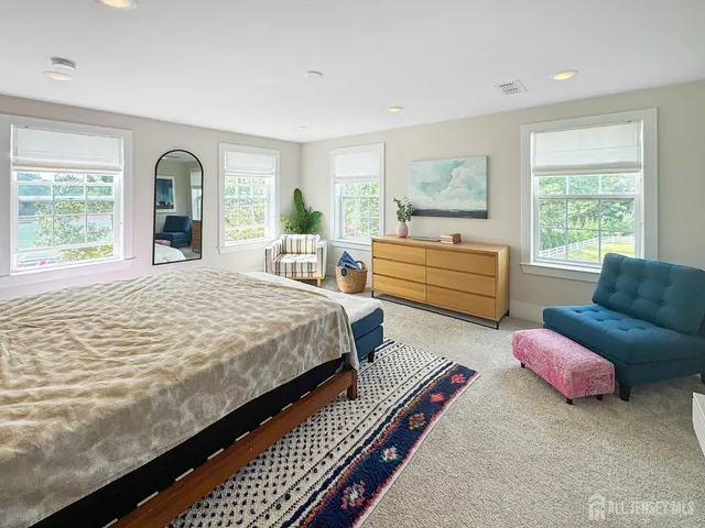 a bedroom with furniture and a large window