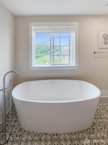 a white bath tub sitting in a bathroom