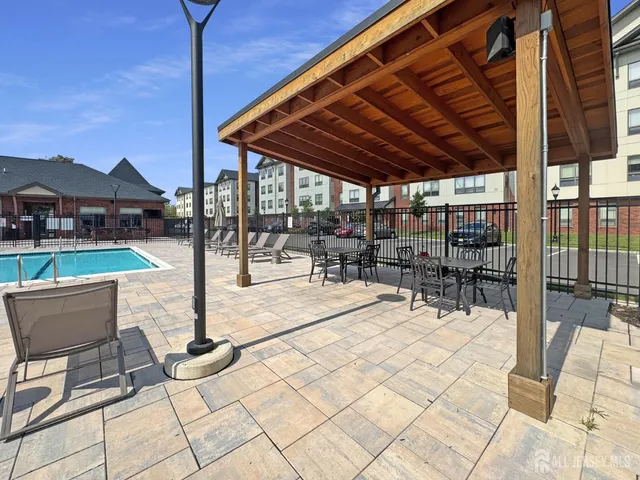 a view of a patio with a table and chairs