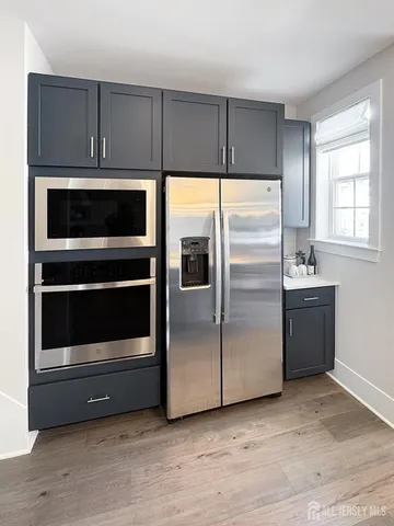a kitchen with cabinets and stainless steel appliances