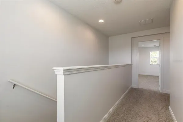 a kitchen with stainless steel appliances a stove top oven a sink a refrigerator and a window
