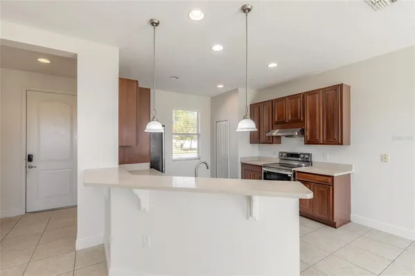 a kitchen with a sink appliances and cabinets