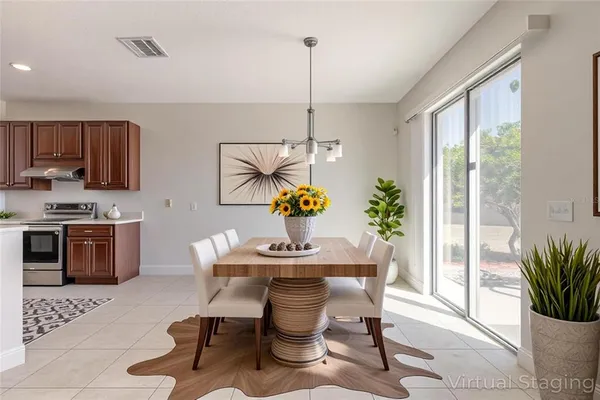 an empty room with a chandelier fan and windows